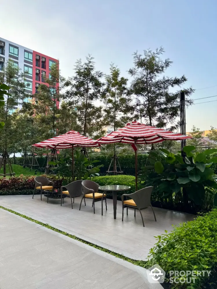 Charming garden patio with stylish seating and umbrellas in modern residential complex