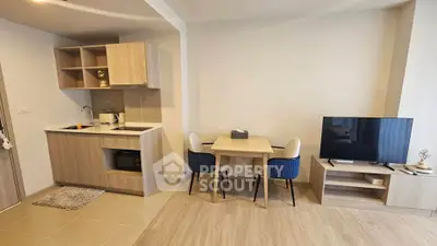 Modern open-plan living room with compact kitchen and dining area
