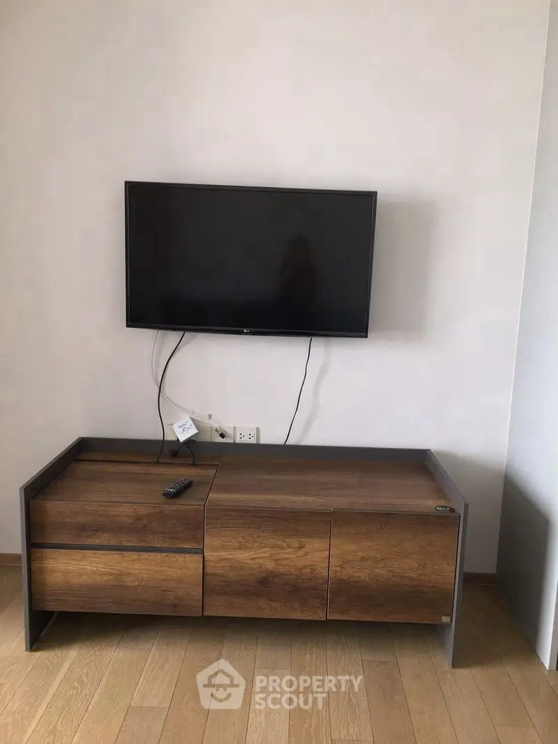 Modern living room with mounted TV and stylish wooden cabinet