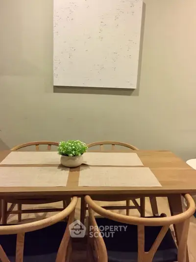 Chic dining area with wooden table and chairs, perfect for cozy meals.