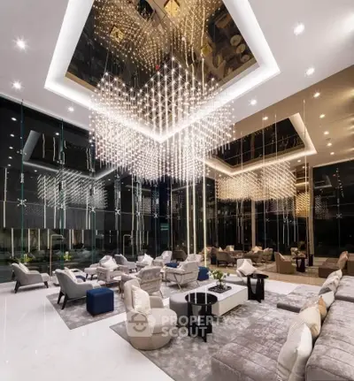 Luxurious modern living room with stunning chandelier and elegant seating area.