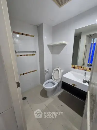 Modern bathroom with sleek white tiles and contemporary fixtures