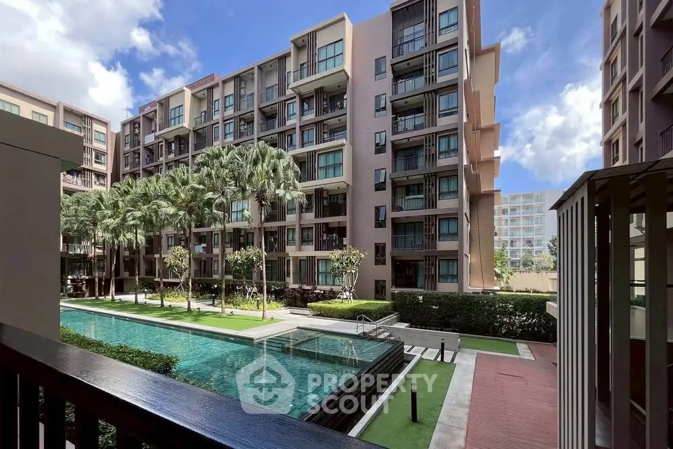 Modern apartment complex with pool and lush landscaping, perfect for urban living.