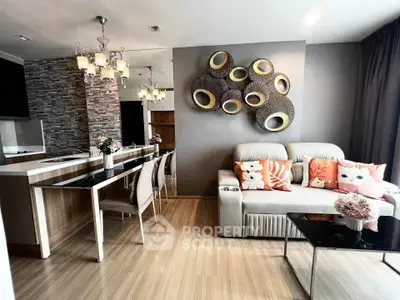 Stylish modern living room with open kitchen, elegant decor, and cozy seating area.