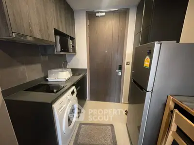 Modern compact kitchen with washing machine and sleek appliances