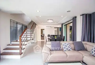 Spacious modern living room with elegant staircase and stylish decor