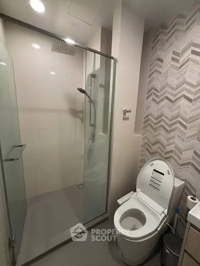 Modern bathroom with glass shower and stylish tile design