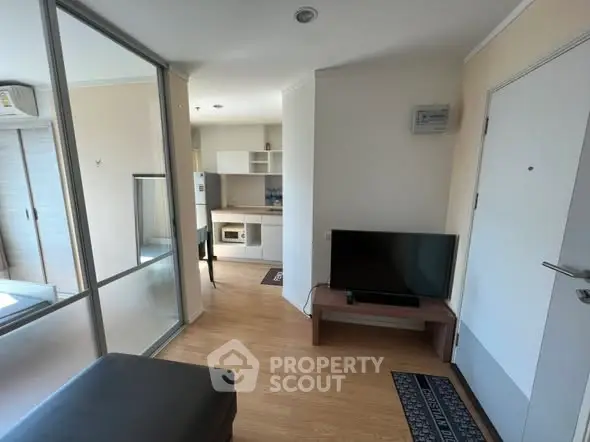 Modern apartment interior with open layout and sleek kitchen design.