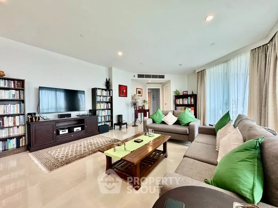 Spacious living room with modern decor and natural light, perfect for relaxation and entertainment.