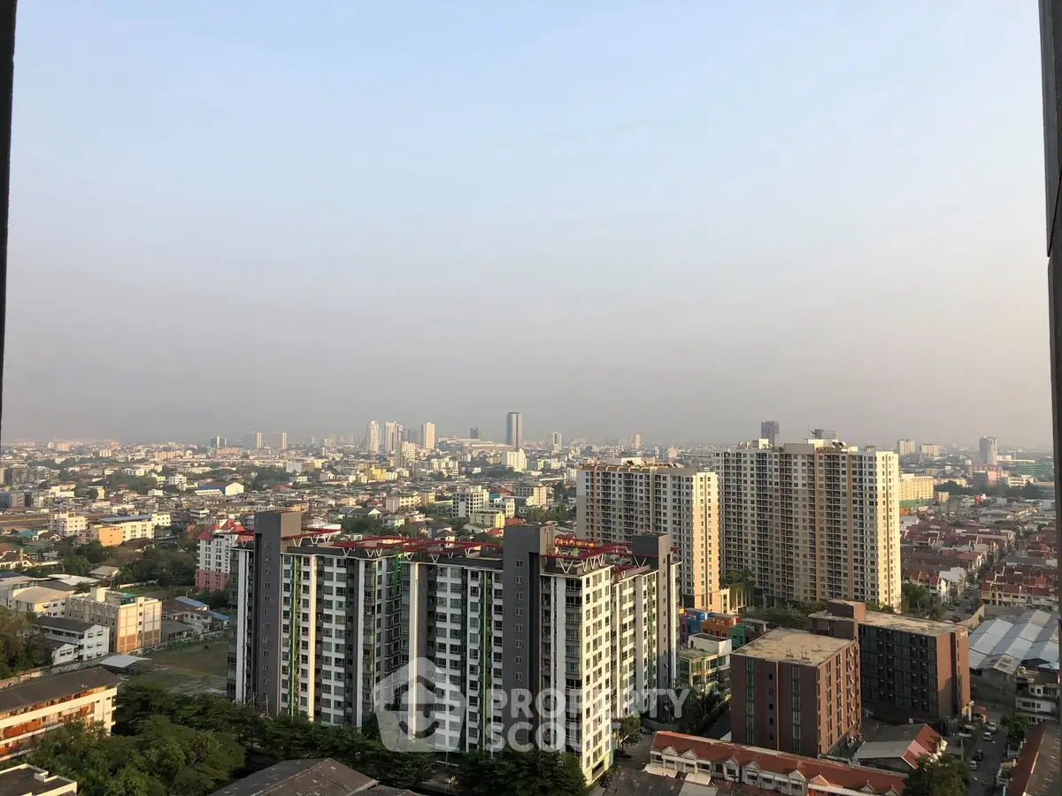 Stunning cityscape view from high-rise apartment balcony showcasing urban skyline.