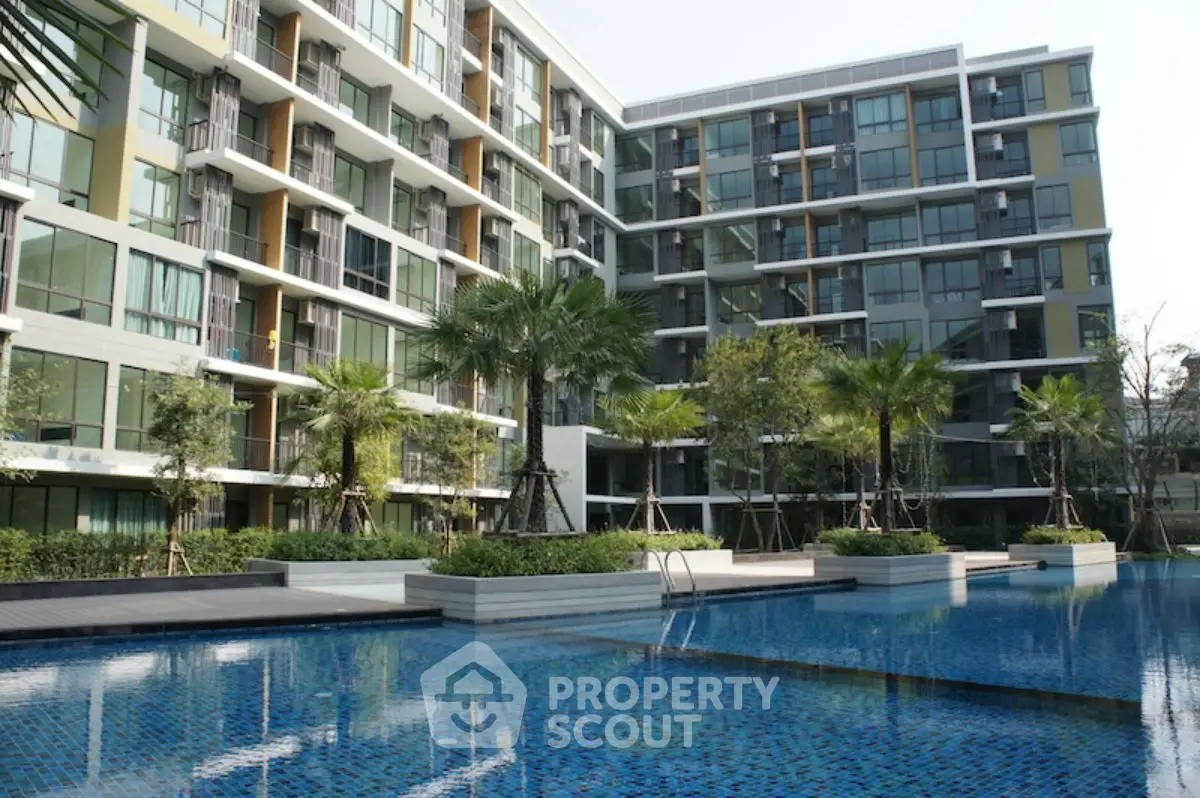 Modern condominium with luxurious pool and lush landscaping, perfect for urban living.