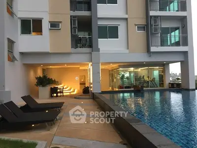 Modern apartment building with pool and gym facilities, perfect for luxury living.