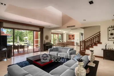 Luxurious open-plan living room with elegant decor and garden view, perfect for modern family living.