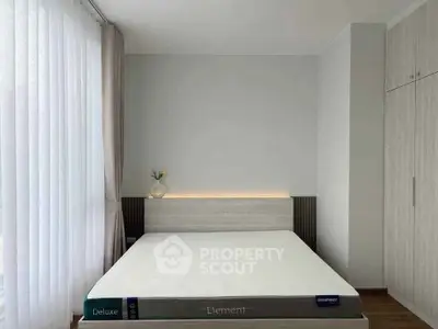 Modern minimalist bedroom with sleek design and ample natural light