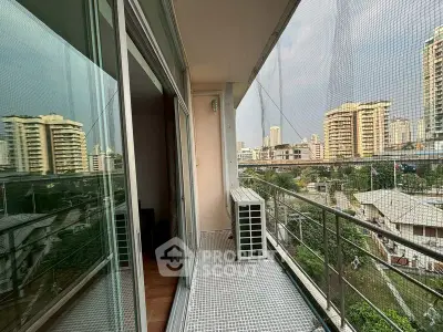 Spacious balcony with city view in modern apartment building