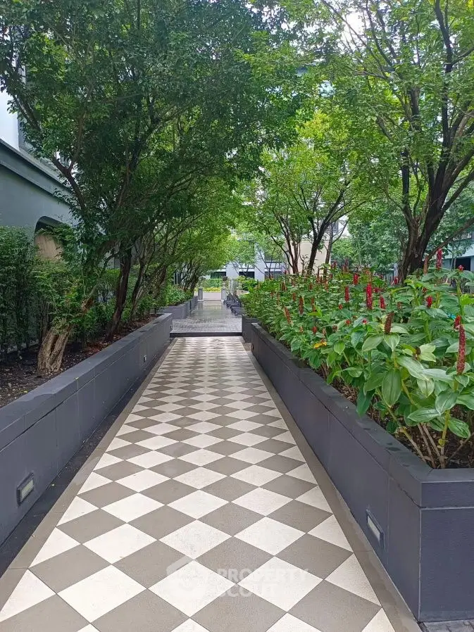 Charming garden pathway with lush greenery and elegant tiled design in a serene residential setting.