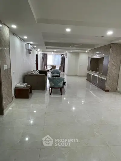 Spacious modern living room with elegant marble flooring and stylish furniture