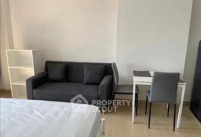 Modern studio apartment with cozy sofa and dining area