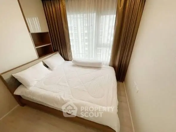 Cozy bedroom with large window and elegant curtains in modern apartment.