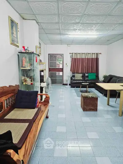 Spacious living room with modern decor and ample seating, perfect for family gatherings.