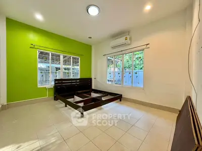 Spacious bedroom with modern design and large windows for natural light