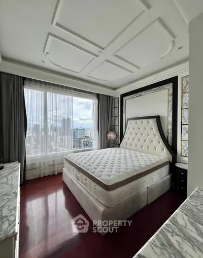 Luxurious bedroom with city view, elegant decor, and large window for natural light.