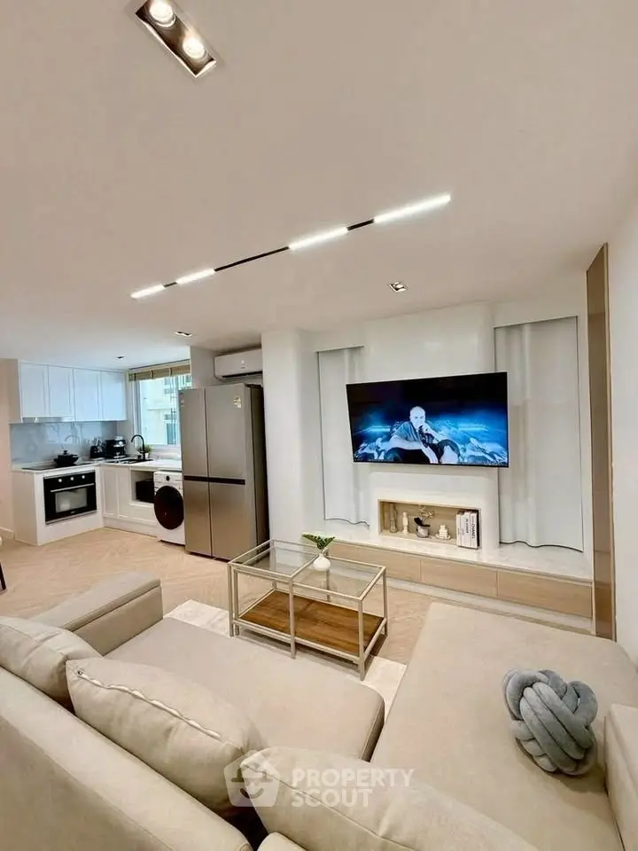 Modern open-plan living room with sleek kitchen and stylish decor