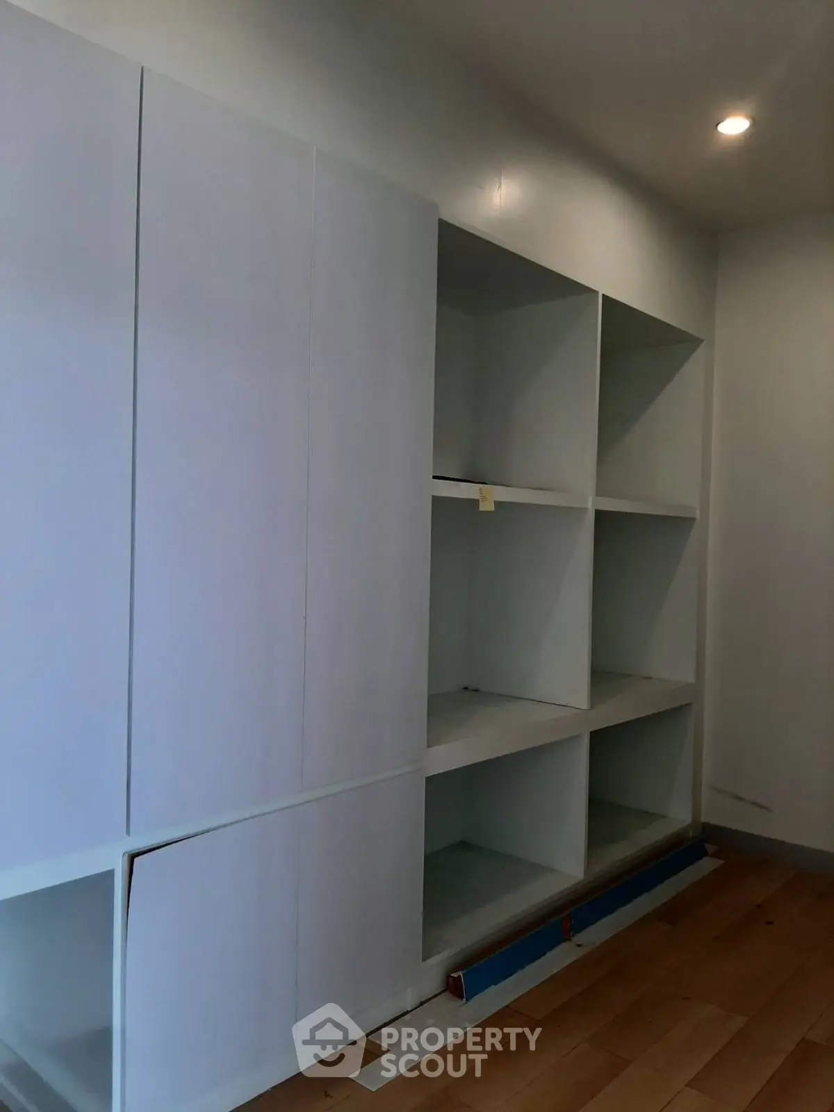 Spacious storage area with built-in shelving in modern home interior.