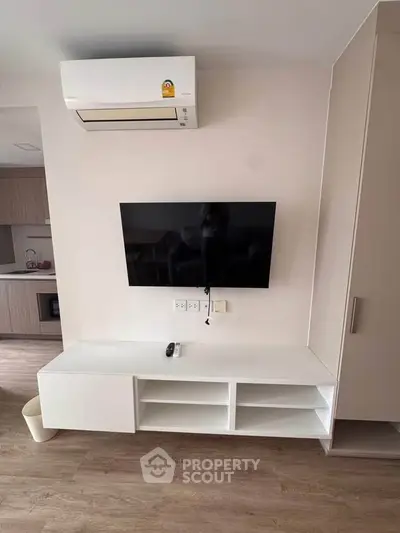Modern living room with wall-mounted TV and sleek air conditioning unit.