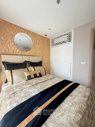 Luxurious bedroom with elegant decor and plush bedding in modern apartment.