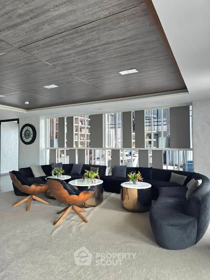 Luxurious modern living room with elegant furniture and large windows offering city views.