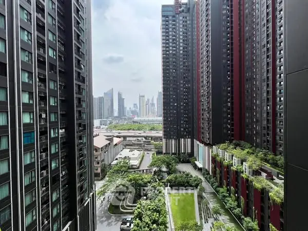 Stunning urban view from high-rise building with lush green landscaping and city skyline.