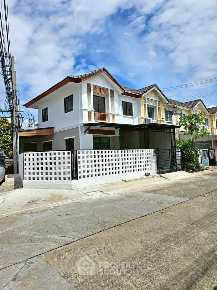 Charming two-story house with modern design and spacious driveway in a serene neighborhood.