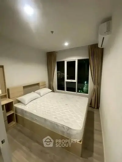 Modern bedroom with large window and minimalist design