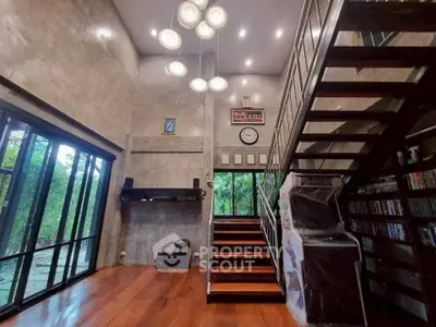 Stunning modern living room with high ceiling and elegant staircase