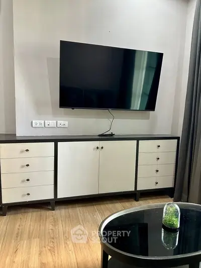Modern living room with sleek TV setup and stylish furniture