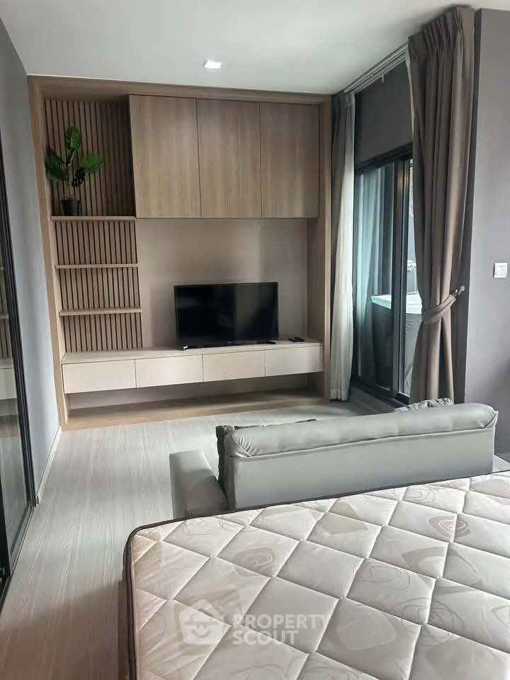 Modern living room with sleek furniture and large window for natural light