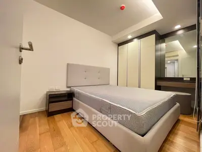 Modern bedroom with stylish furniture and wooden flooring