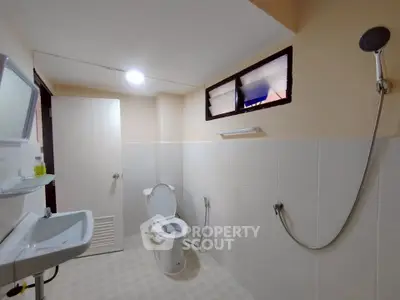 Spacious bathroom with modern fixtures and natural light.