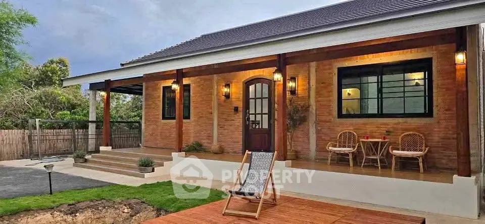 Charming brick house with inviting porch and lush garden