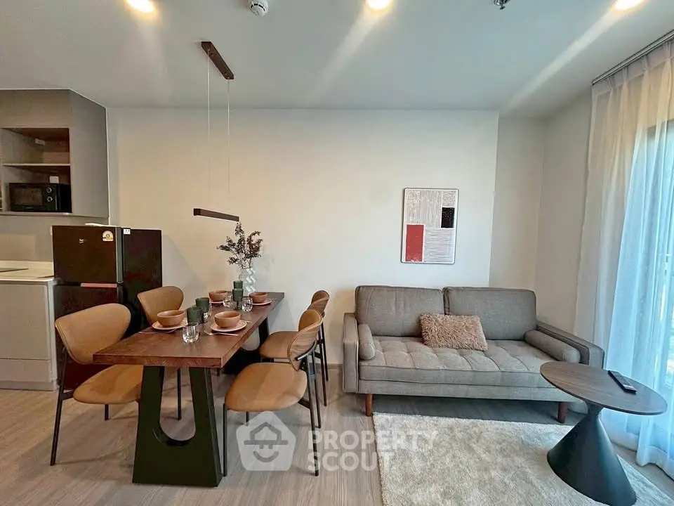 Modern living room with dining area, stylish furniture, and natural light