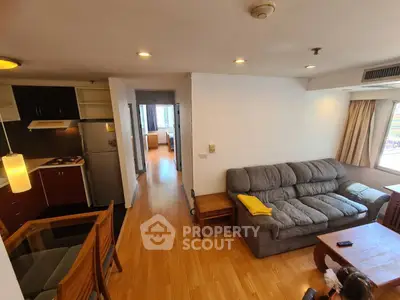 Spacious living room with cozy sofa and modern kitchen in open layout apartment