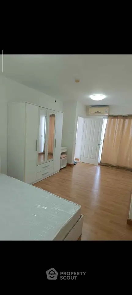 Spacious bedroom with modern furnishings and natural light