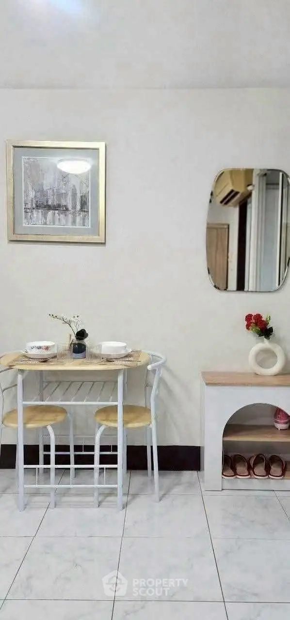 Charming dining nook with modern decor and elegant wall art in cozy apartment.