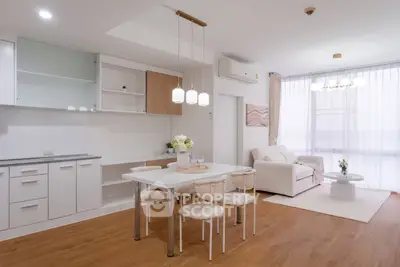 Modern open-plan living room and kitchen with elegant decor and natural light