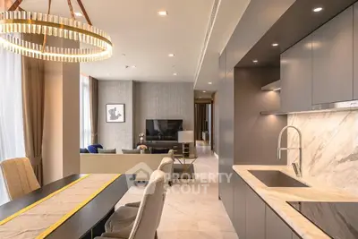 Luxurious open-plan living room and kitchen with modern decor and elegant lighting