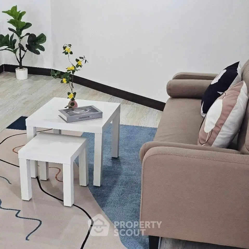Modern living room with stylish sofa, chic coffee table, and vibrant decor accents.
