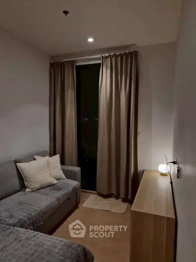 Cozy living room with modern sofa and ambient lighting, perfect for relaxation.