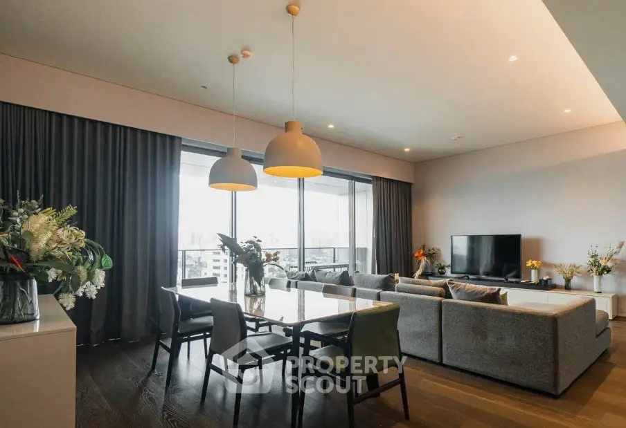 Spacious modern living room with large windows and elegant dining area.