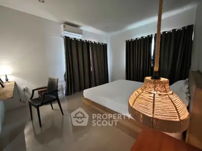 Cozy bedroom with modern decor and ambient lighting, featuring a comfortable bed and stylish furnishings.